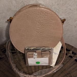 A round tan crossbody with card holder